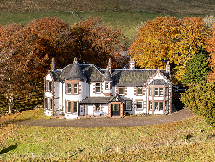 Exterior of Kinclune House with autumnal trees surrounding